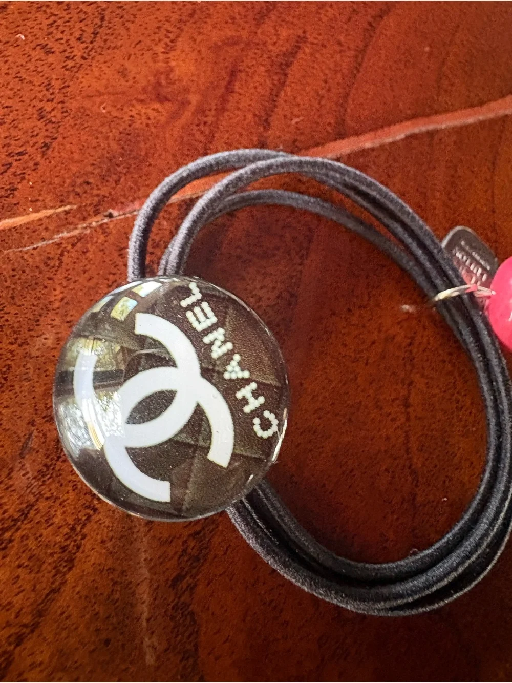 CHANEL Black Hair Tie with White Interlocking CC and Pink Bead